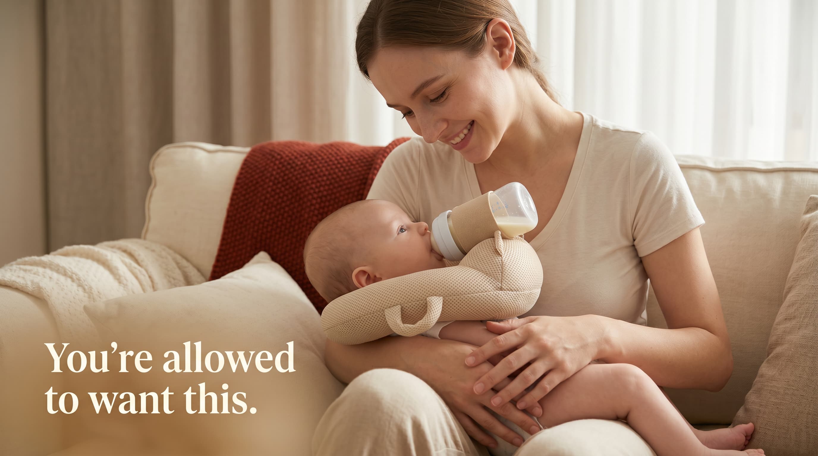 A parent smiling down at her baby, feeding hands-free with the FeedNest while staying right beside him.
