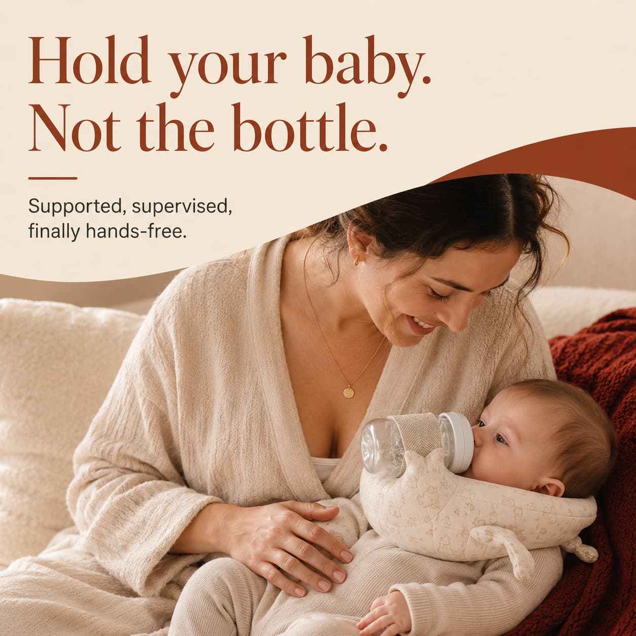 A parent holding her baby close while the FeedNest supports the bottle — supported, supervised, hands-free.
